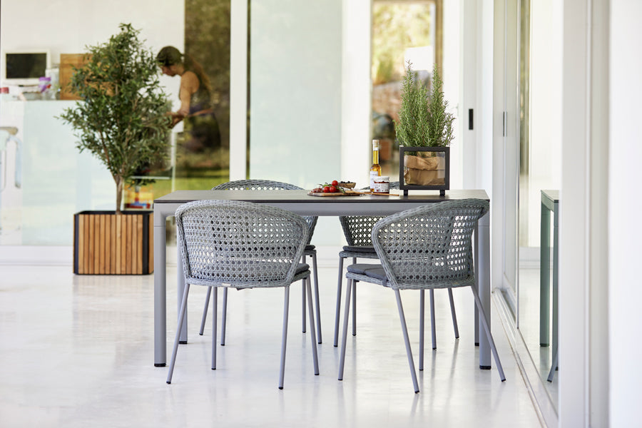 Drop Dining Table by Cane-Line, showing drop dining table in live shot.