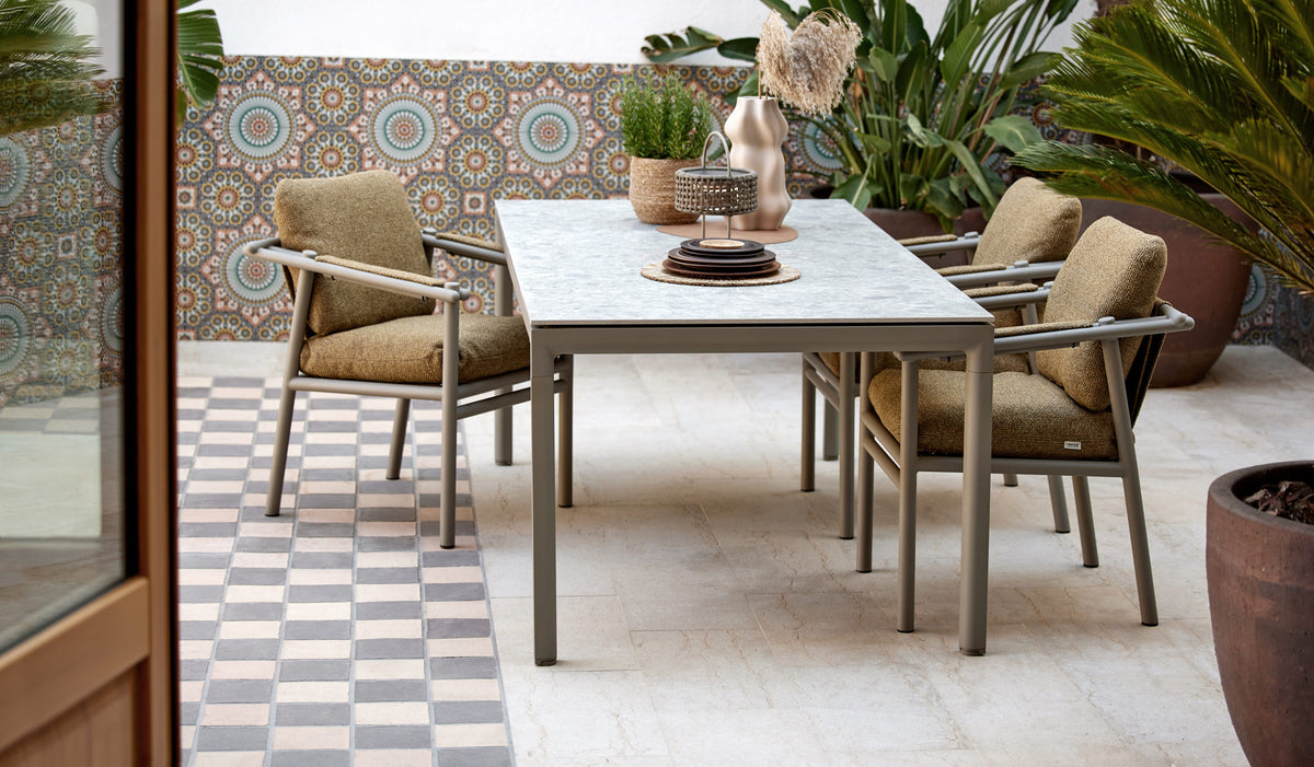 Drop Dining Table by Cane-Line, showing drop dining table in live shot.