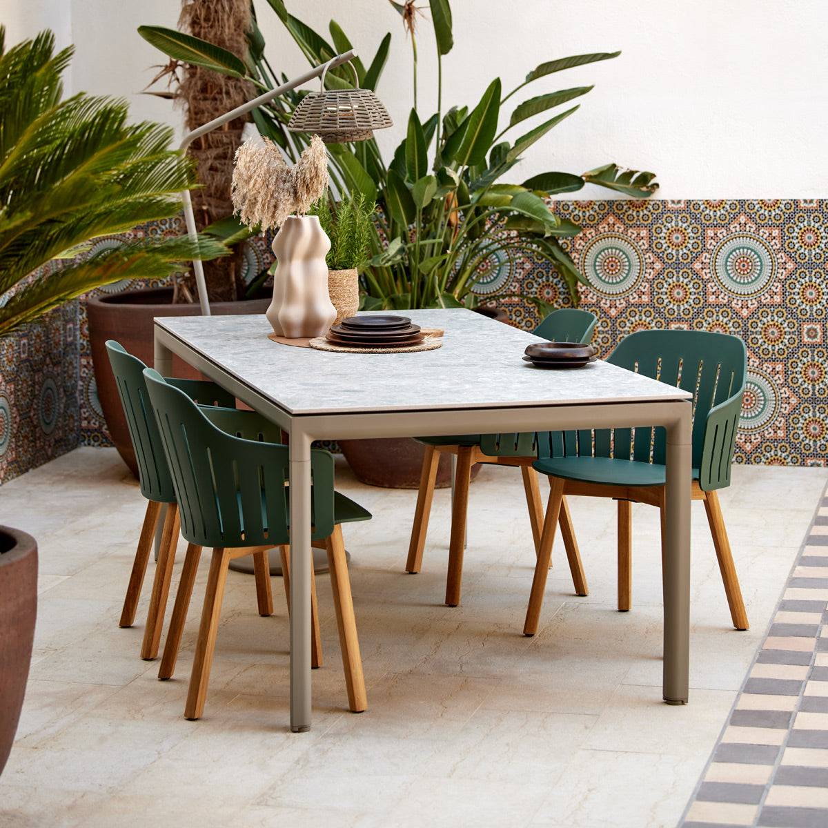 Drop Dining Table by Cane-Line, showing drop dining table in live shot.