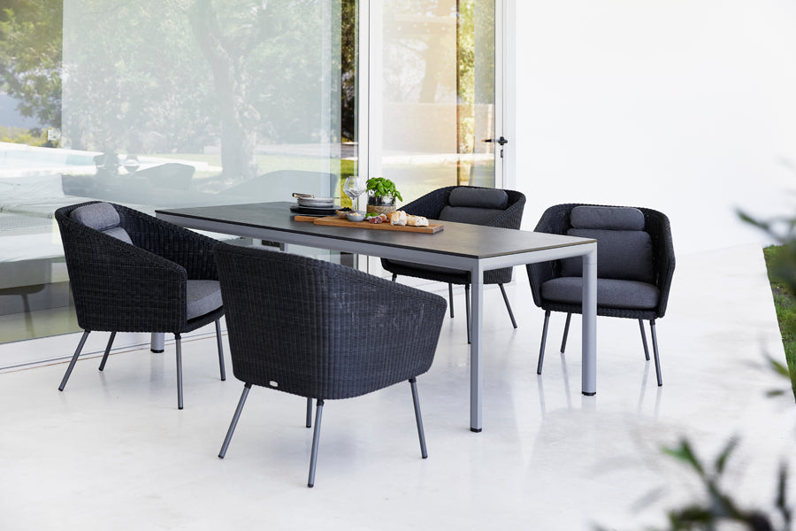 Drop Dining Table by Cane-Line, showing drop dining table in live shot.