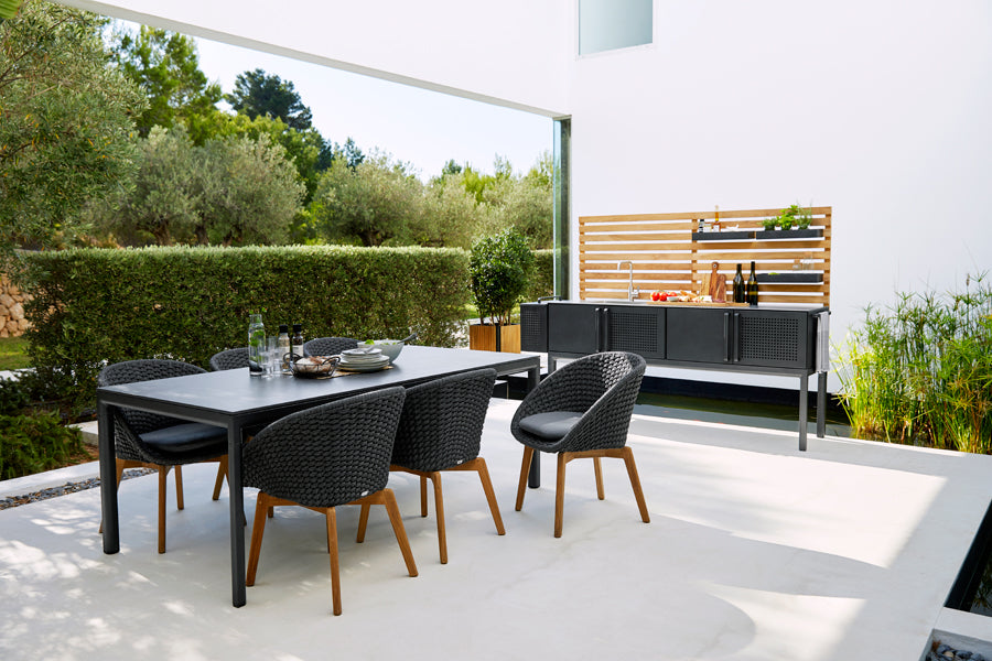Drop Dining Table by Cane-Line, showing drop dining table in live shot.