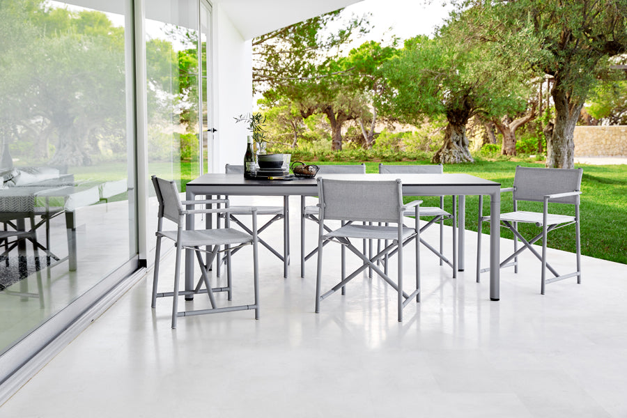 Drop Dining Table by Cane-Line, showing drop dining table in live shot.