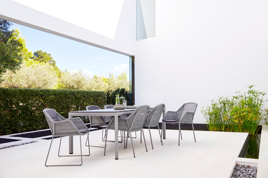 Drop Dining Table by Cane-Line, showing drop dining table in live shot.