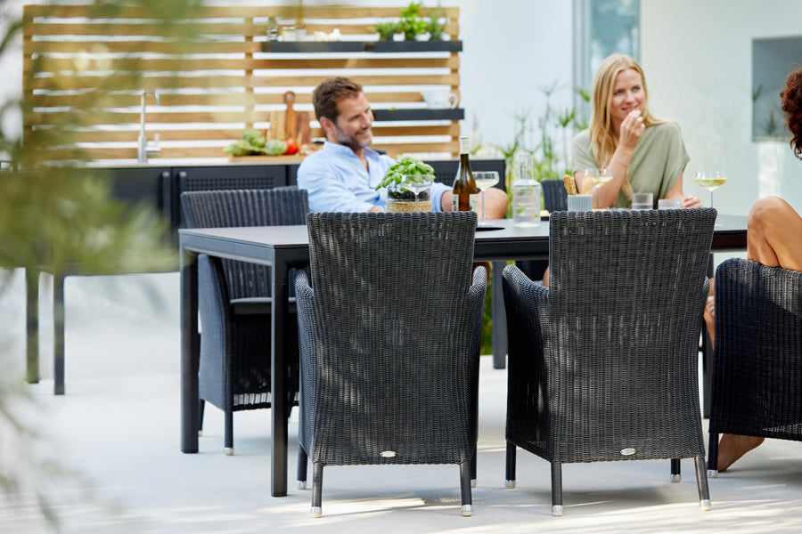 Drop Dining Table by Cane-Line, showing drop dining table in live shot.
