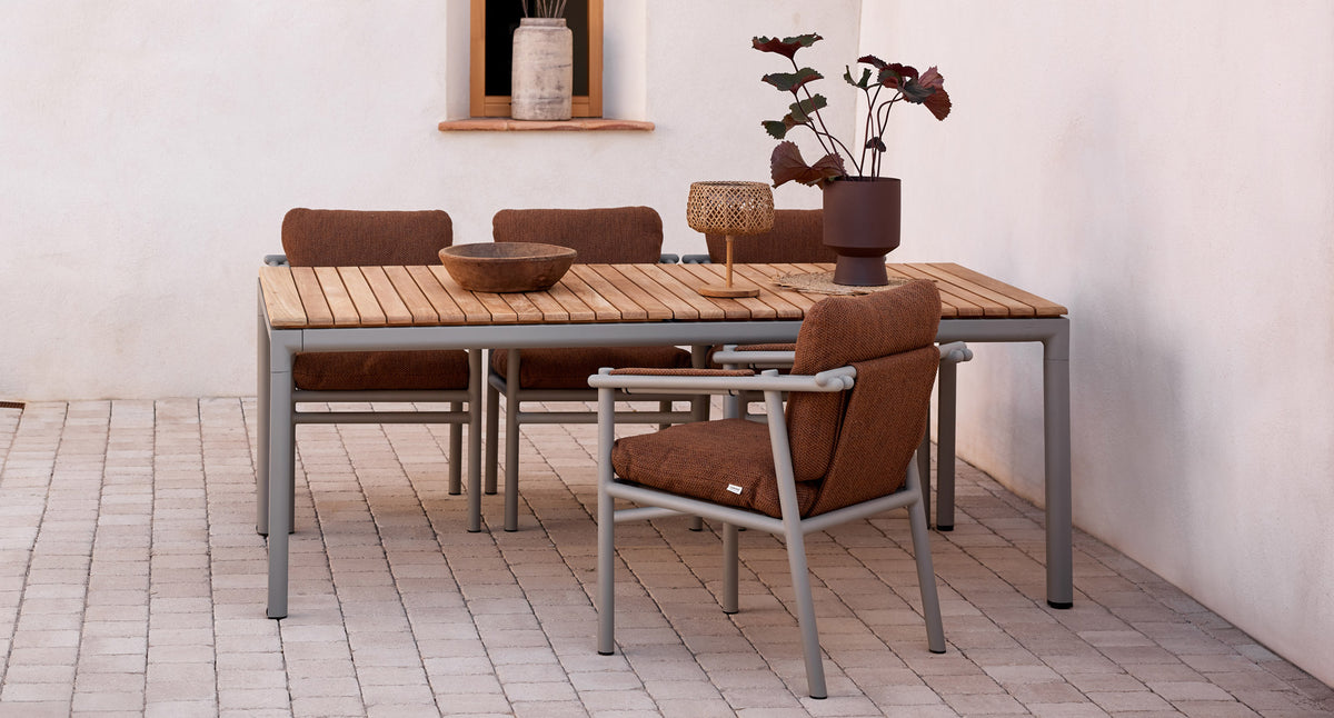 Drop Dining Table with 2pcs Extensions by Cane-Line, showing drop dining table with 2pcs extensions in live shot.