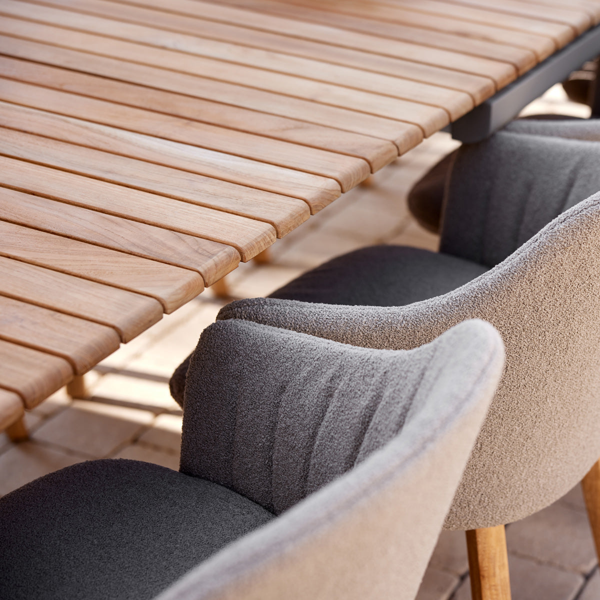 Drop Dining Table with 2pcs Extensions by Cane-Line, showing closeup view of drop dining table with 2pcs extensions in live shot.