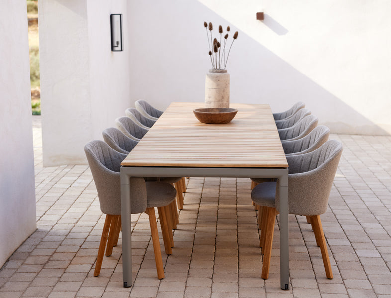Drop Dining Table with 2pcs Extensions by Cane-Line, showing drop dining table with 2pcs extensions in live shot.