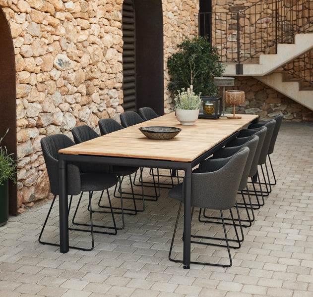 Drop Dining Table with 2pcs Extensions by Cane-Line, showing drop dining table with 2pcs extensions in live shot.