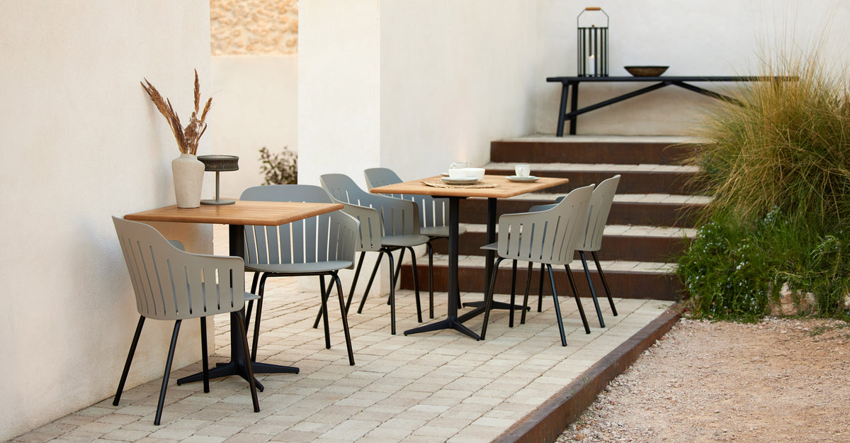Drop Rectangle Cafe Table by Cane-Line, showing drop rectangle cafe table in live shot.