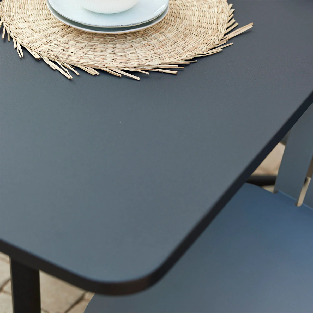 Drop Rectangle Cafe Table by Cane-Line, showing closeup view of drop rectangle cafe table in live shot.