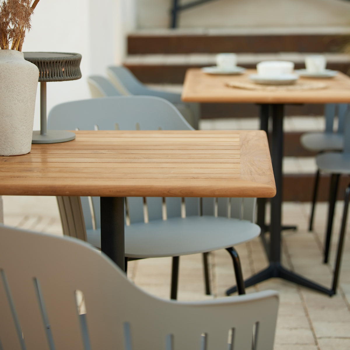 Drop Rectangle Cafe Table by Cane-Line, showing closeup view of drop rectangle cafe table in live shot.