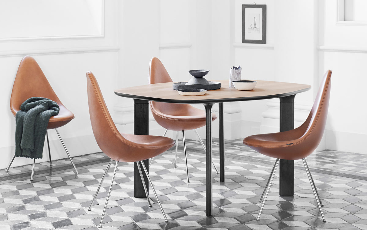 Drop Upholstery Chair by Fritz Hansen, showing drop upholstery chairs in live shot.