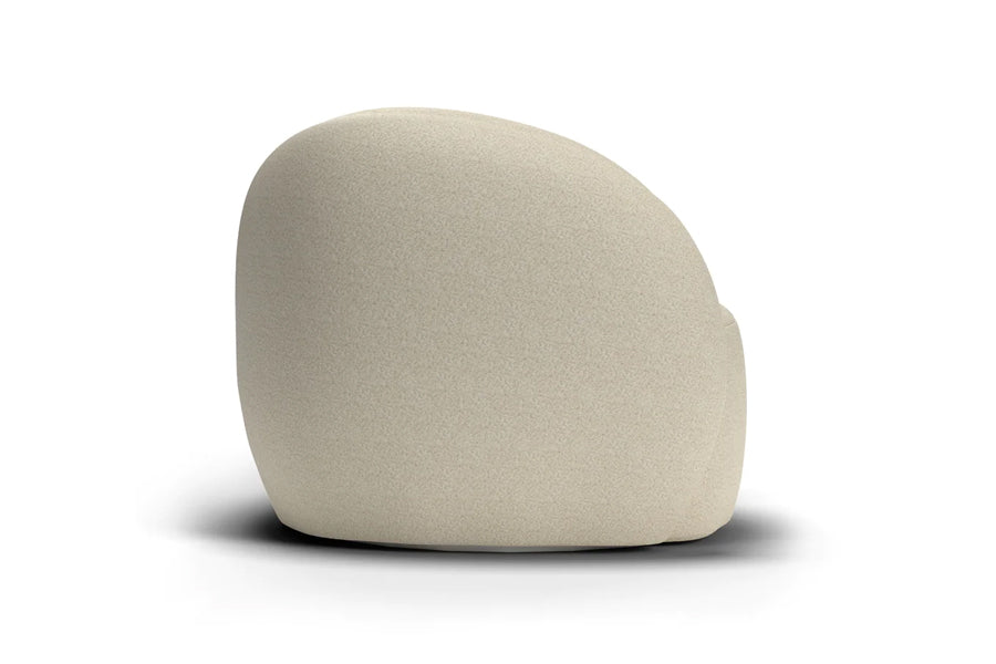 Dune Swivel Lounge Chair by Mobital, showing side view of dune swivel lounge chair in cream teddy fabric.