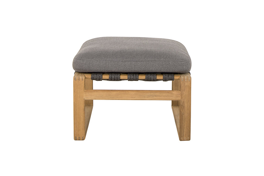 Endless Soft Footstool by Cane-Line, showing side view of endless soft footstool in dark grey soft rope/teak/grey airtouch cushion set.