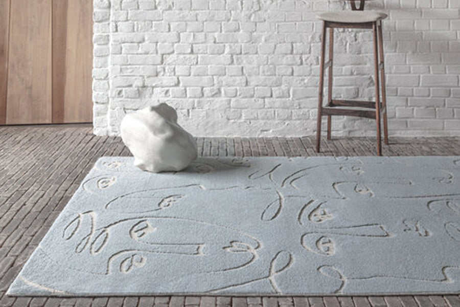Faces Woven Rug by Ligne Pure, showing closeup view of faces woven rug in live shot.