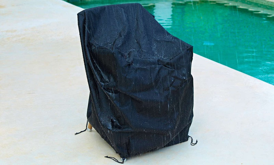 Flip Folding Teak Dining Chair by Cane-Line, showing cover for flip folding teak dining chair in live shot.