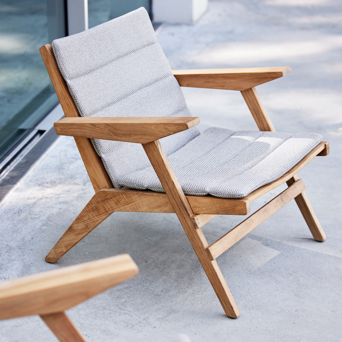 Flip Lounge Chair by Cane-Line, showing flip lounge chairs in live shot.