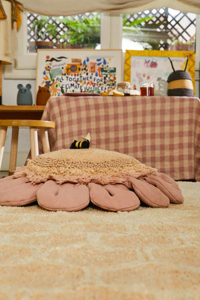 Planet Bee Floor Cushion by Lorena Canals, showing planet bee floor cushion in live shot.