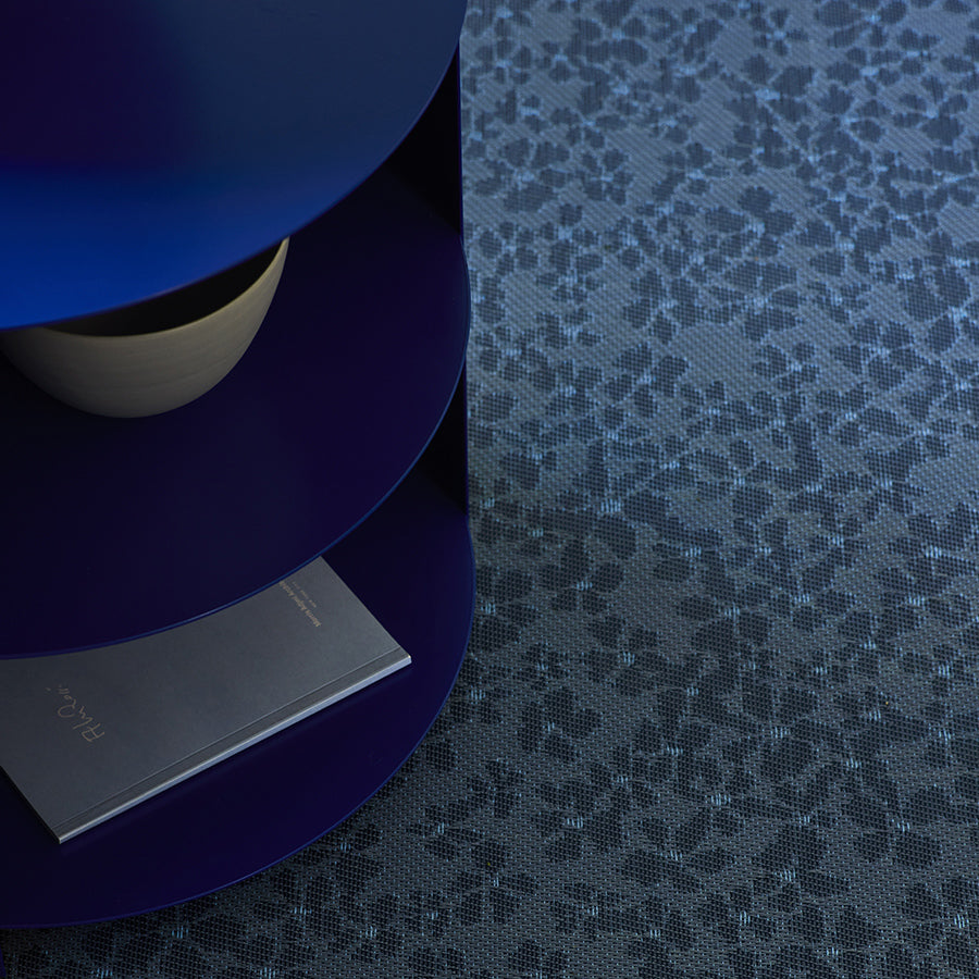 Flora Woven Floor Mat by Chilewich, showing closeup view of flora woven floor mat in live shot.