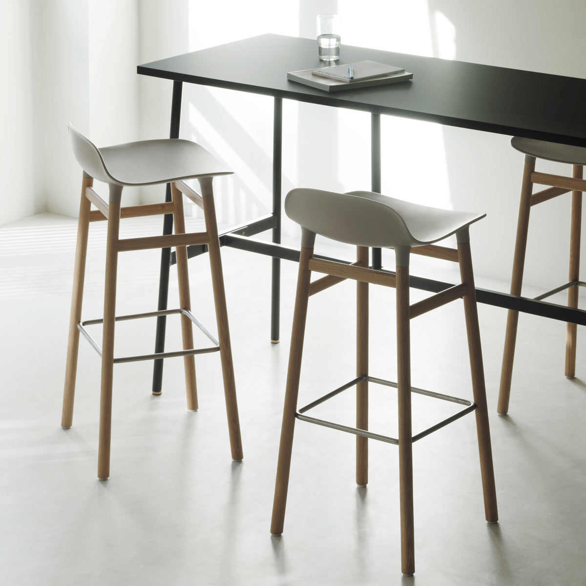 Form 34" High Barstool by Normann Copenhagen, showing form 34" high barstools in live shot.