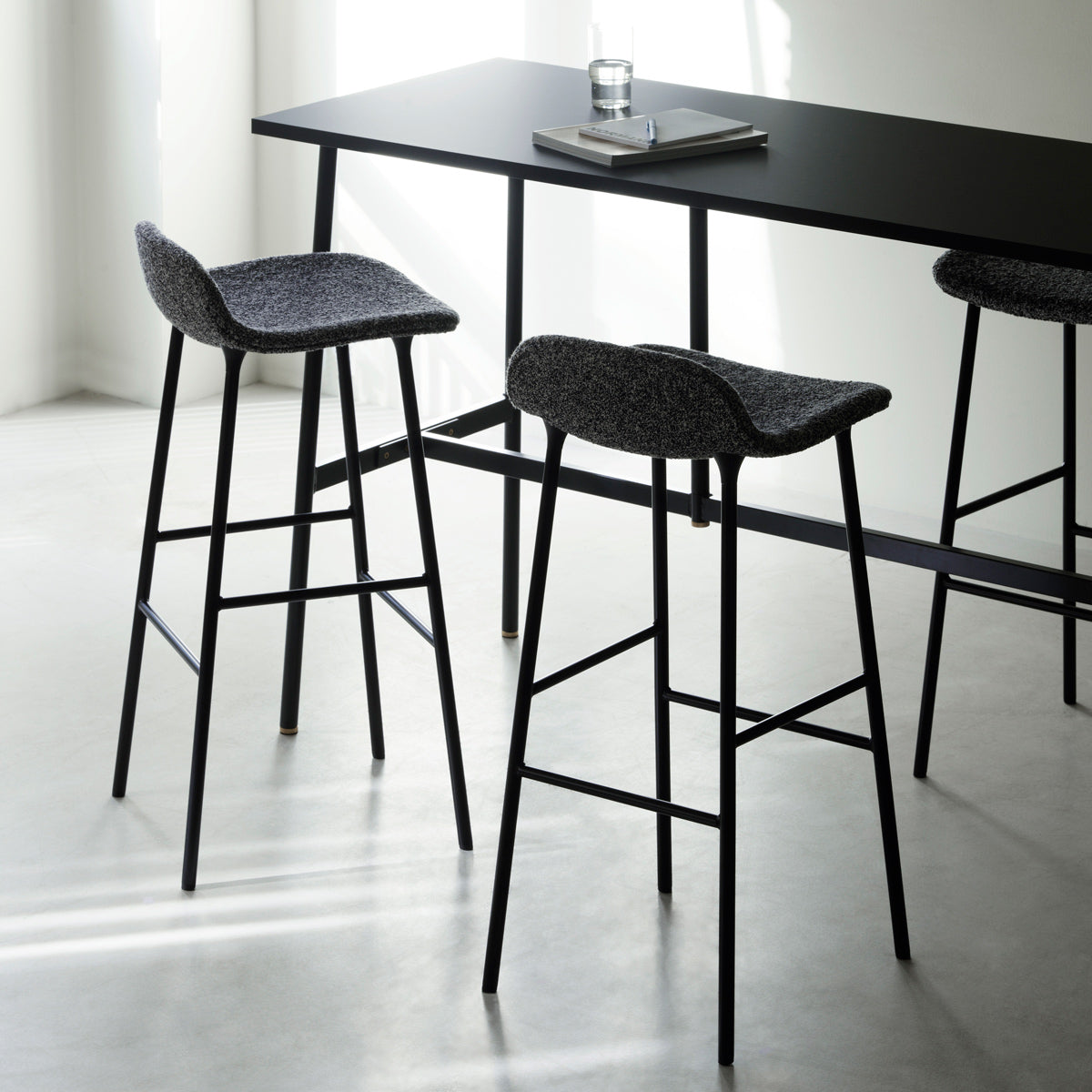 Form 34" High Full Upholstery Steel Barstool by Normann Copenhagen, showing form 34" high full upholstery steel barstools in live shot.