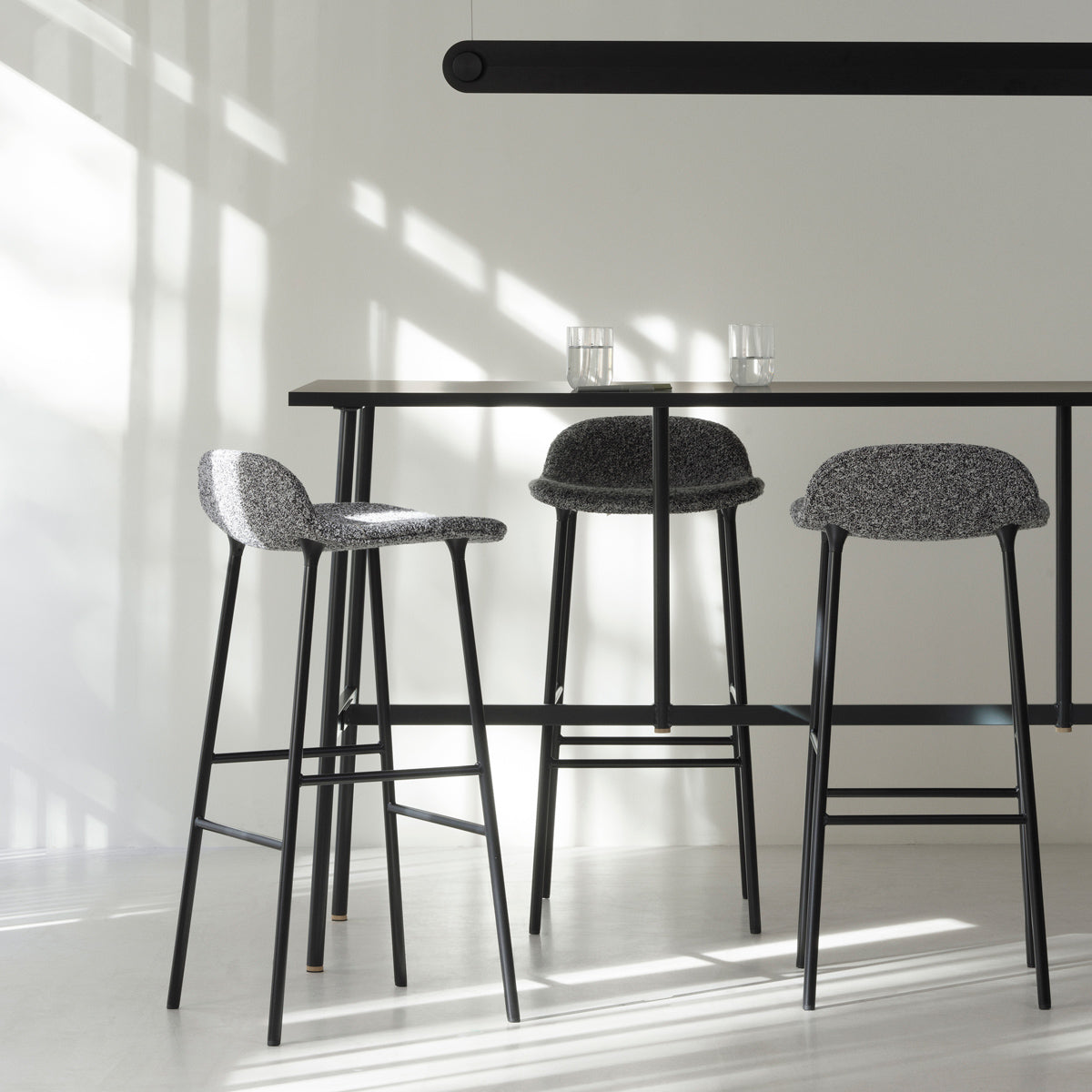 Form 34" High Full Upholstery Steel Barstool by Normann Copenhagen, showing form 34" high full upholstery steel barstools in live shot.