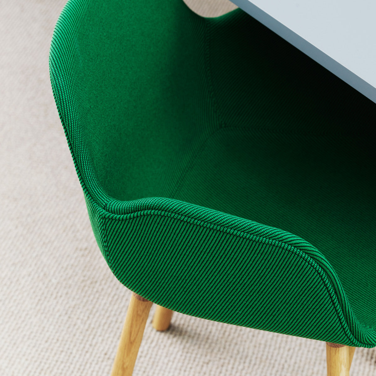 Form Full Upholstery Wood Chair by Normann Copenhagen, showing closeup view of form full upholstery wood chairs in live shot.