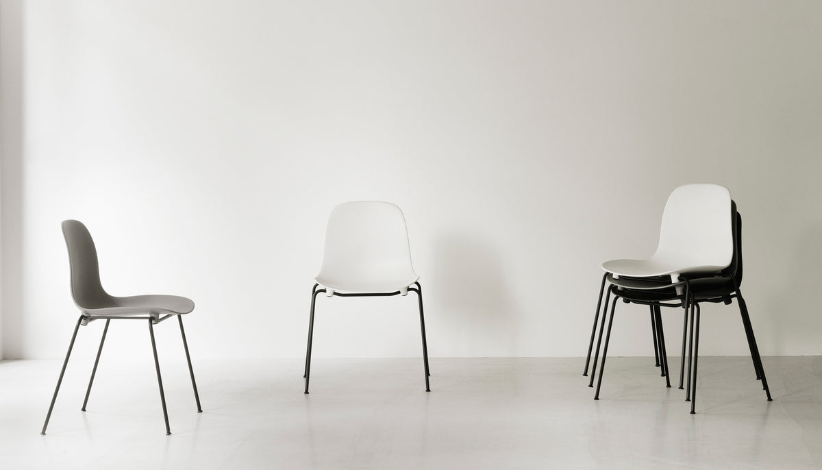 Form Stacking Chair by Normann Copenhagen, showing form stacking chairs in live shot.