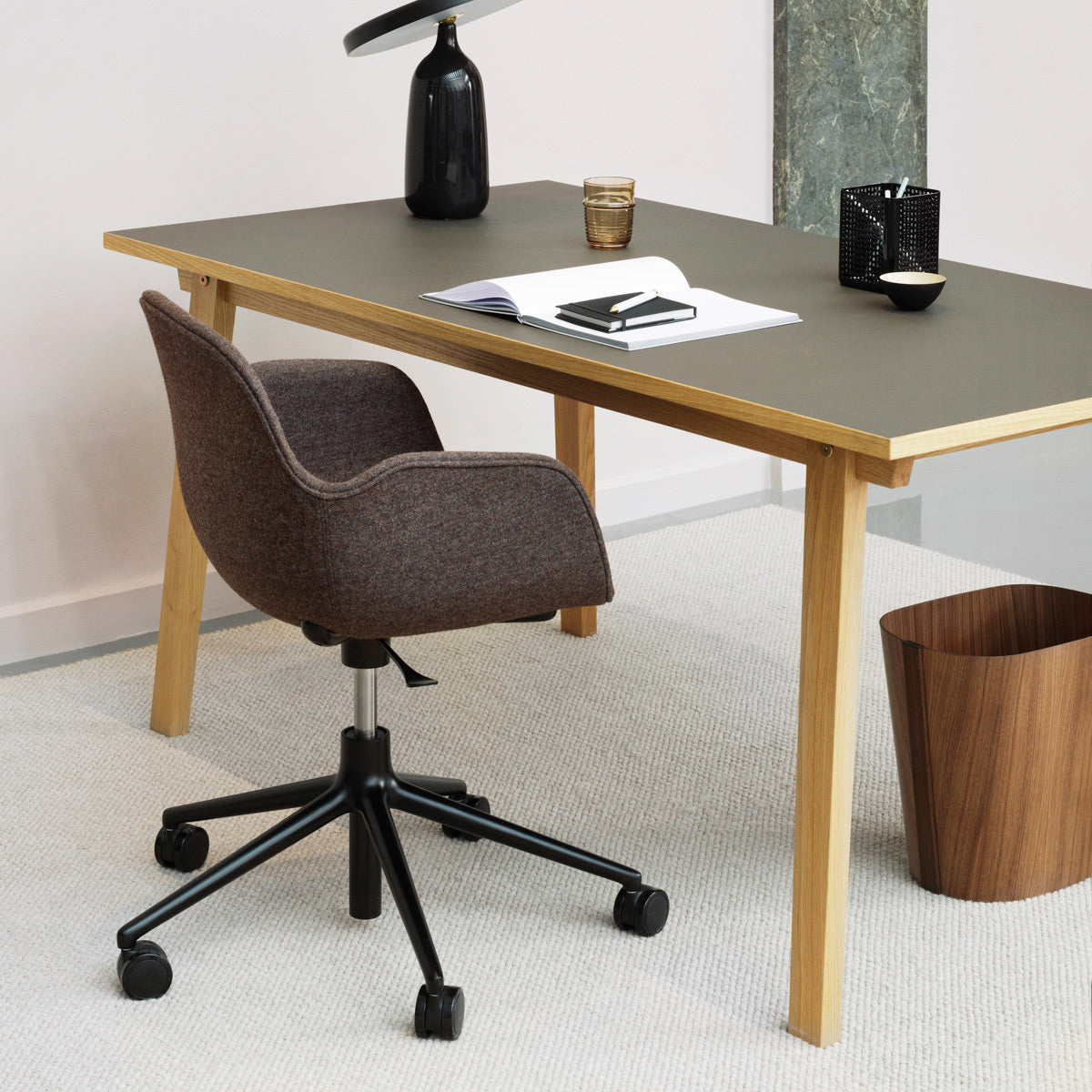 Form Swivel Gaslift Office Chair by Normann Copenhagen, showing form swivel gaslift office chair with table in live shot.
