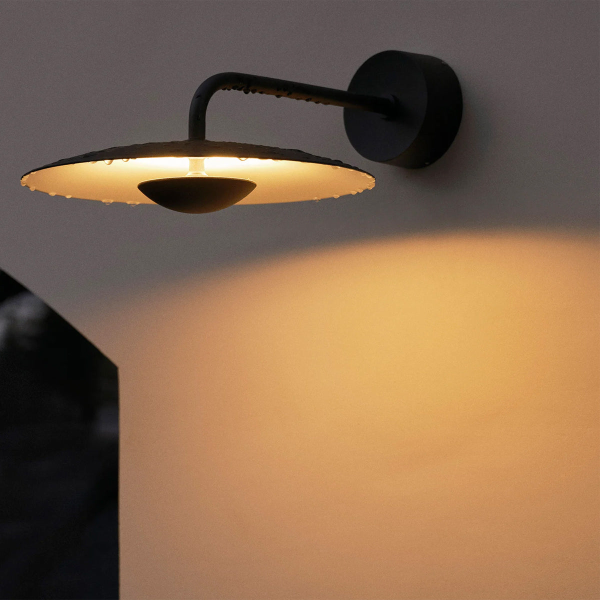 Ginger IP65 Outdoor Wall Light by Marset, showing ginger ip65 outdoor wall light in live shot. 