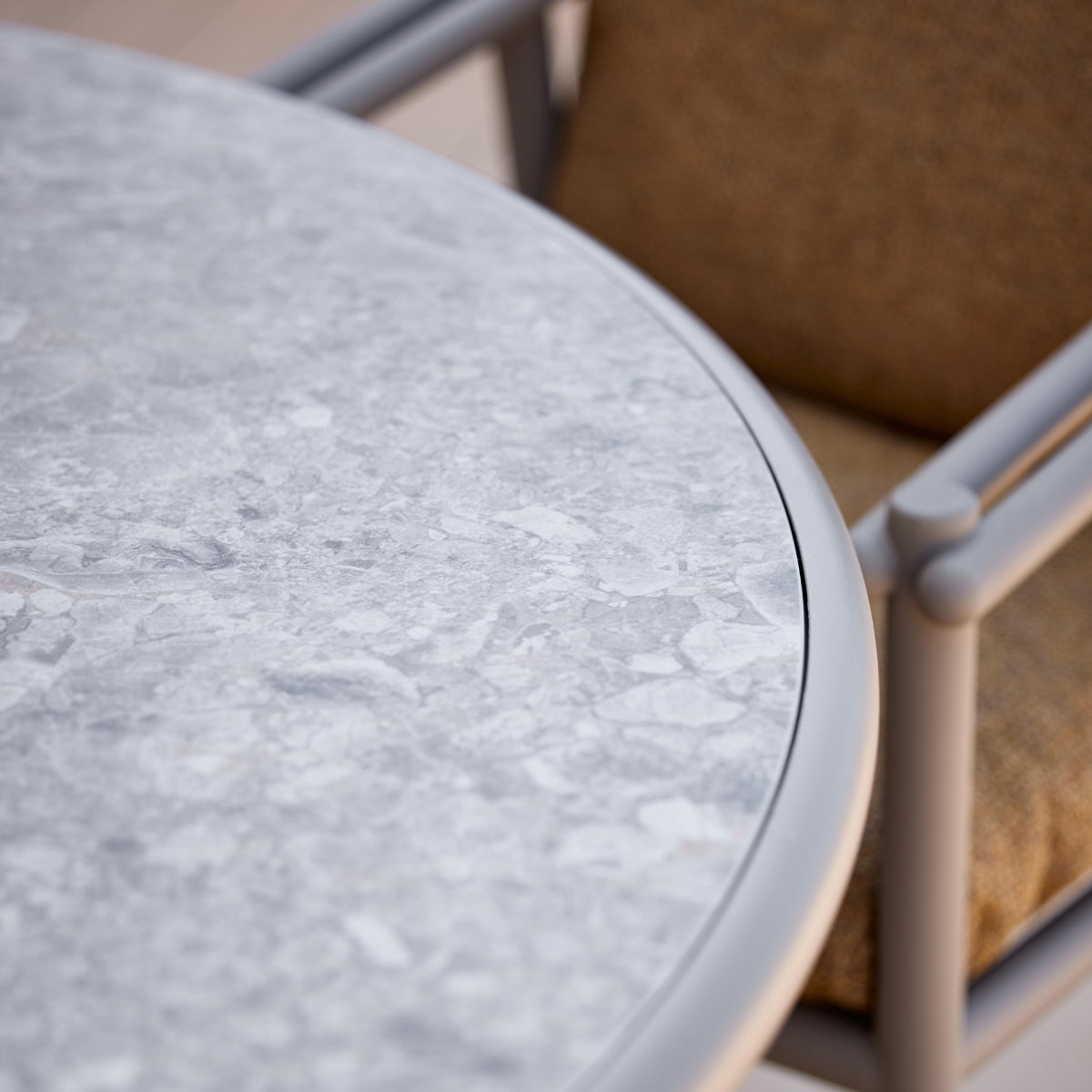 Glaze Dining Table by Cane-Line, showing closeup view of glaze dining table in live shot.