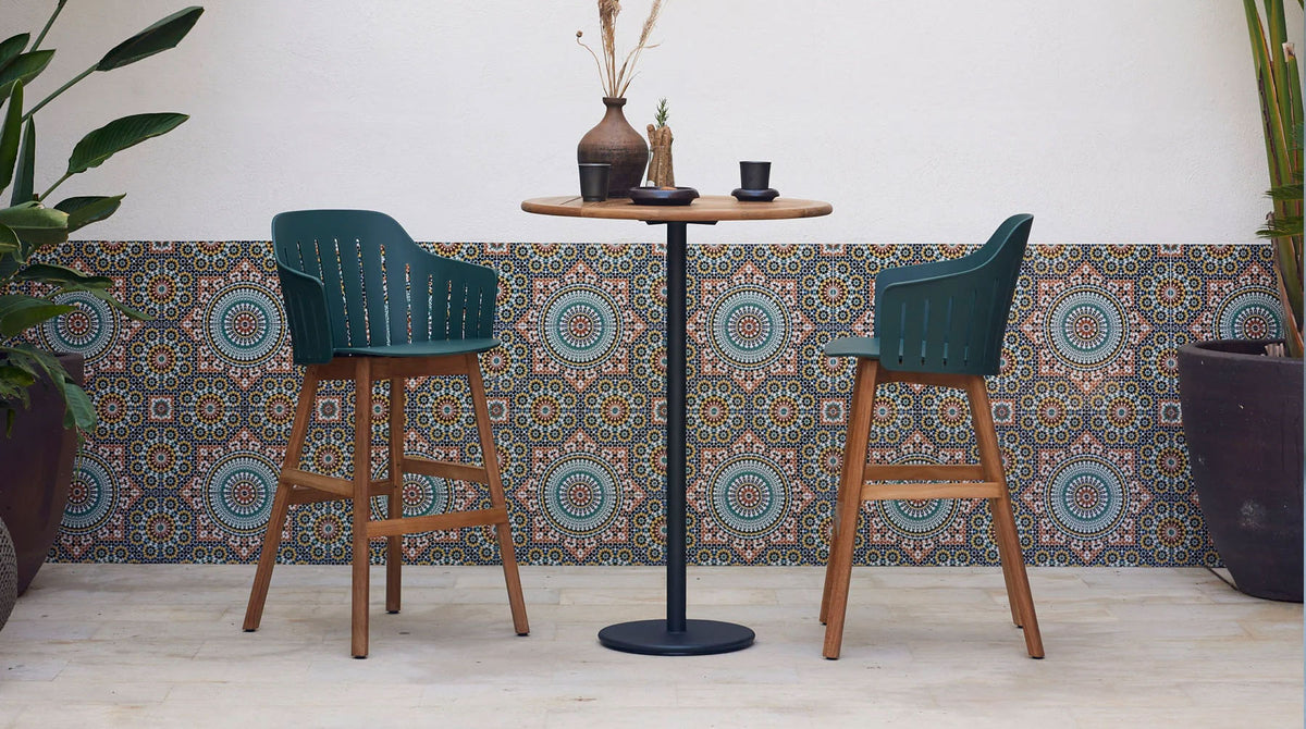 Go 24" Bar Table by Cane-Line, showing go 24" bar table in live shot.