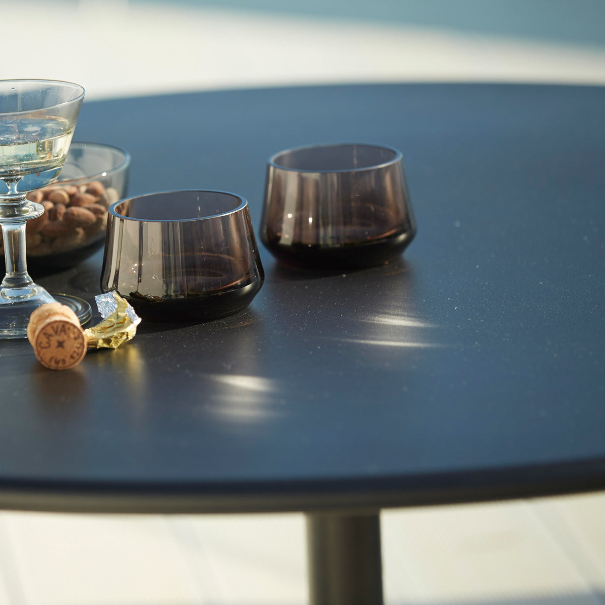 Go 24" Bar Table by Cane-Line, showing closeup view of go 24" bar table in live shot.