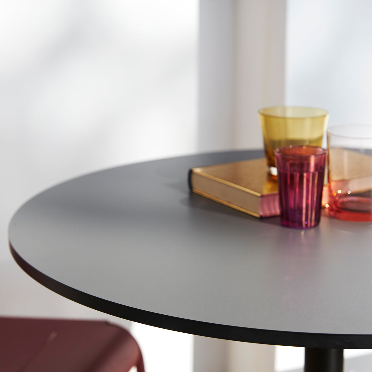 Go 24" Bar Table by Cane-Line, showing closeup view of go 24" bar table in live shot.