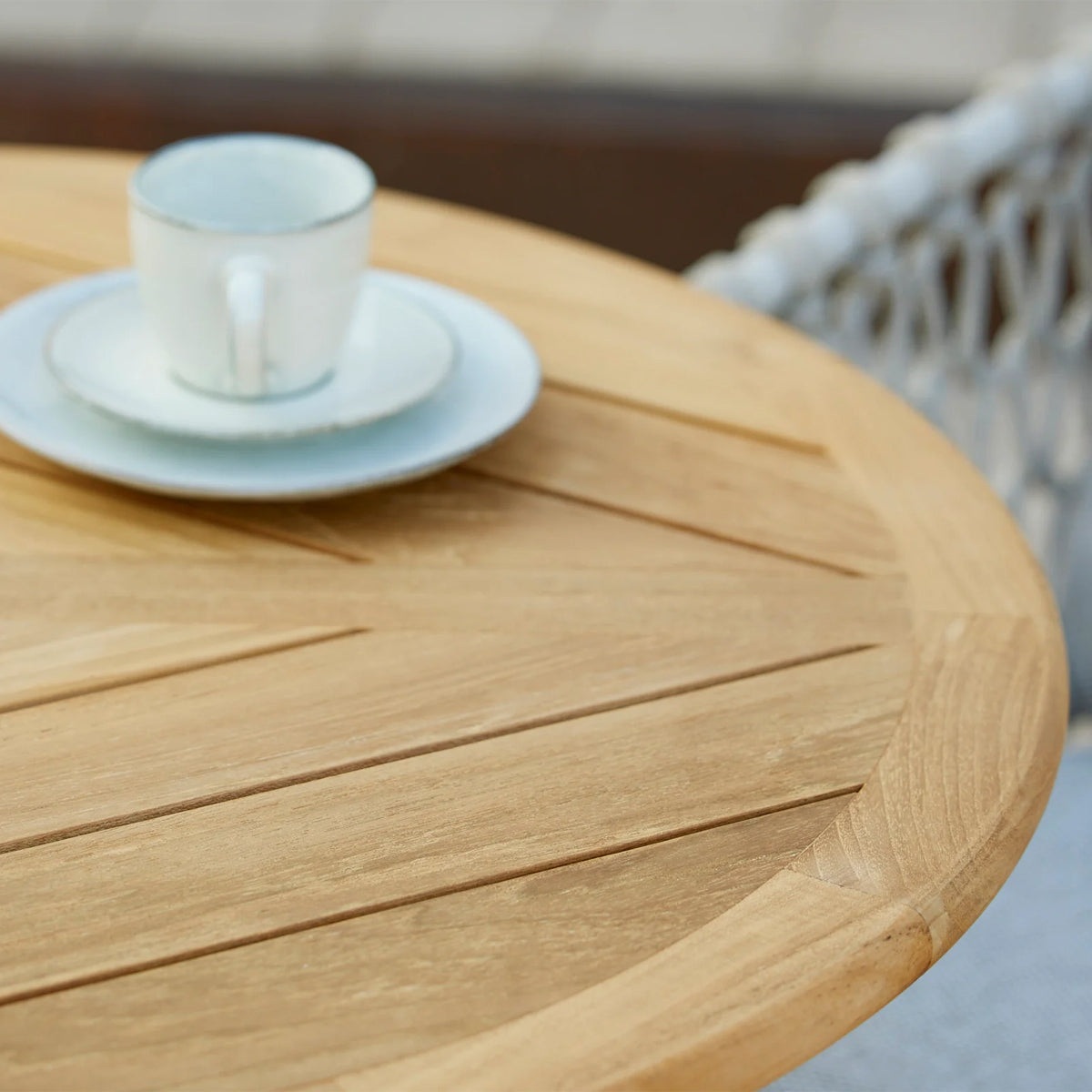 Go 24" Cafe Table by Cane-Line, showing closeup view of go 24" cafe table in live shot.