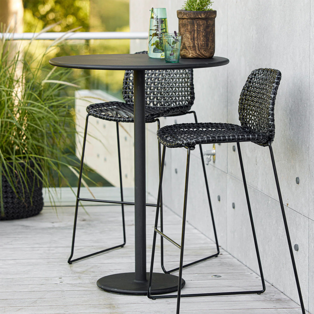 Go 32" Bar Table by Cane-Line, showing go 32" bar table in live shot.