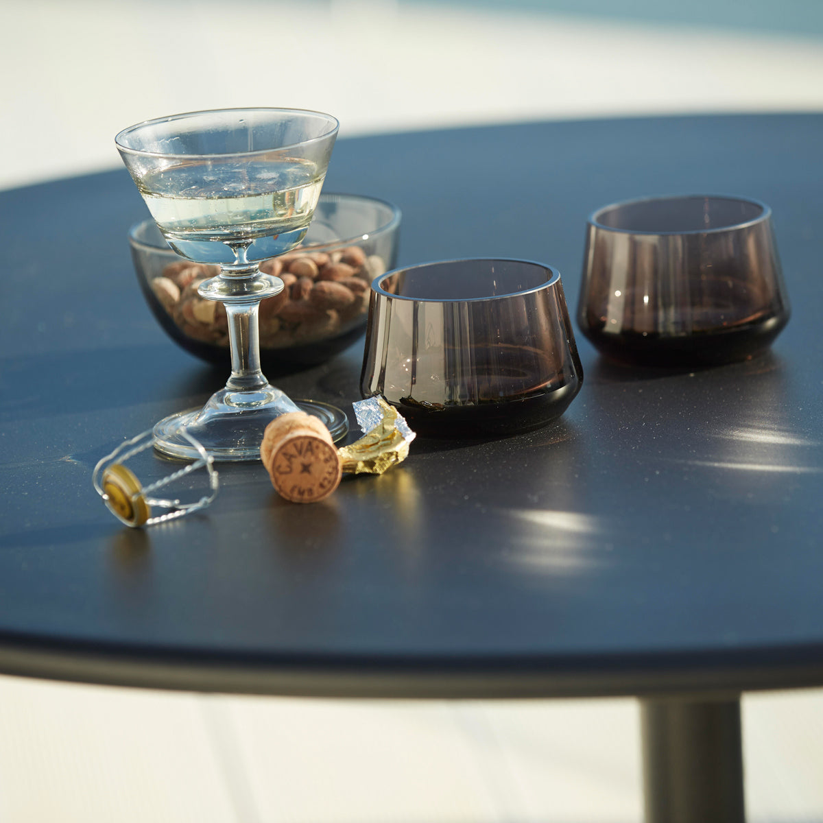 Go 32" Cafe Table by Cane-Line, showing closeup view of go 32" cafe table in live shot.