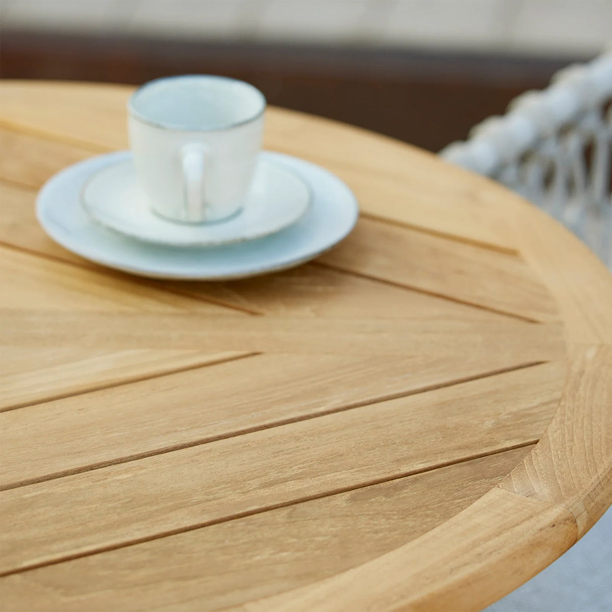 Go 32" Cafe Table by Cane-Line, showing closeup view of go 32" cafe table in live shot.