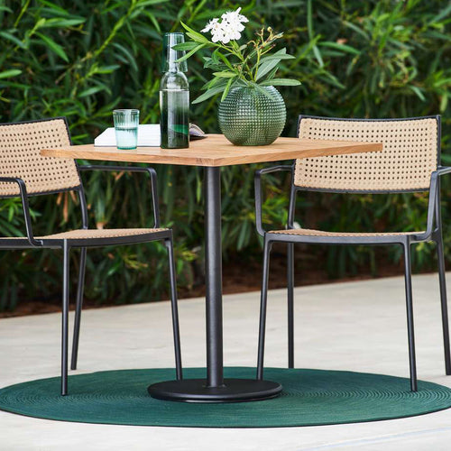 Go Cafe Table by Cane-Line, showing go cafe table with chairs in live shot.