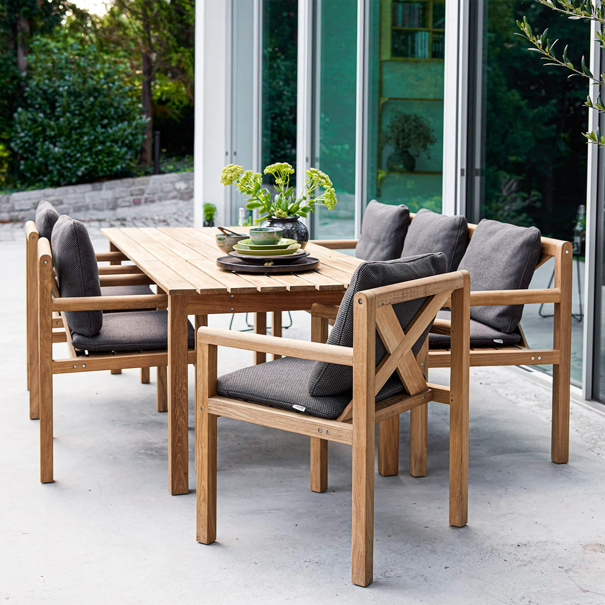 Grace Bench by Cane-Line, showing grace bench in live shot.