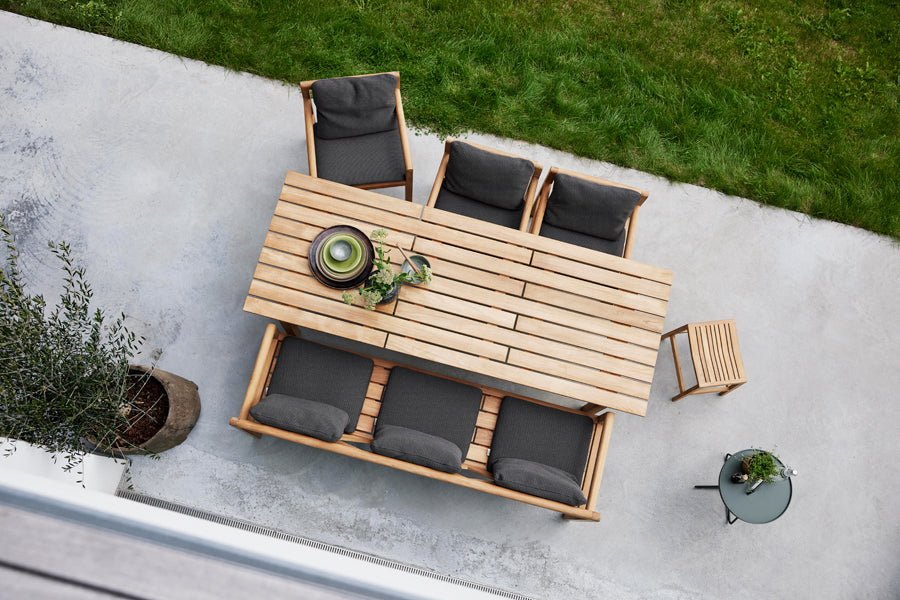 Grace Bench by Cane-Line, showing grace bench in live shot.