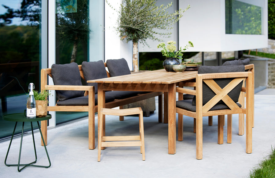 Grace Bench by Cane-Line, showing grace bench in live shot.
