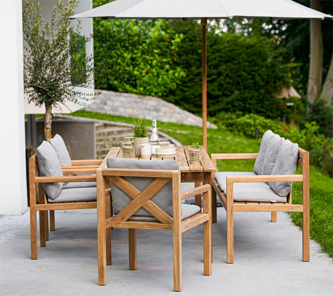 Grace Bench by Cane-Line, showing grace bench in live shot.