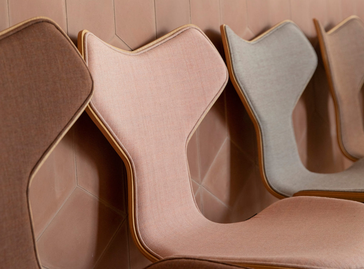 Grand Prix Front Upholstery Swivel Chair by Fritz Hansen, showing closeup view of grand prix front upholstery swivel chairs in live shot.