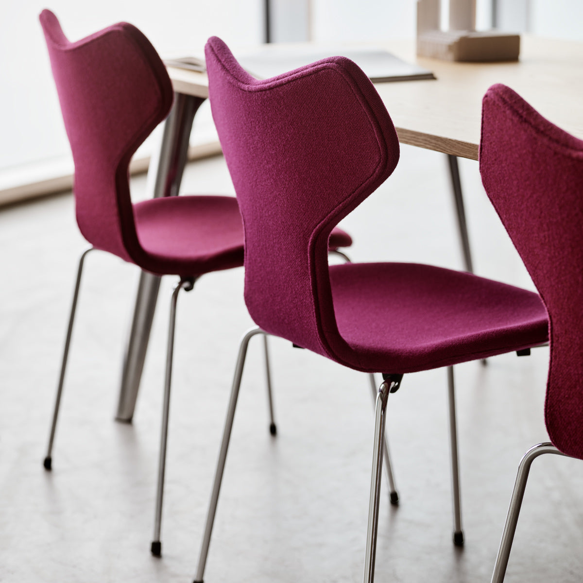 Grand Prix Full Upholstery Chair by Fritz Hansen, showing grand prix full upholstery chairs in live shot.