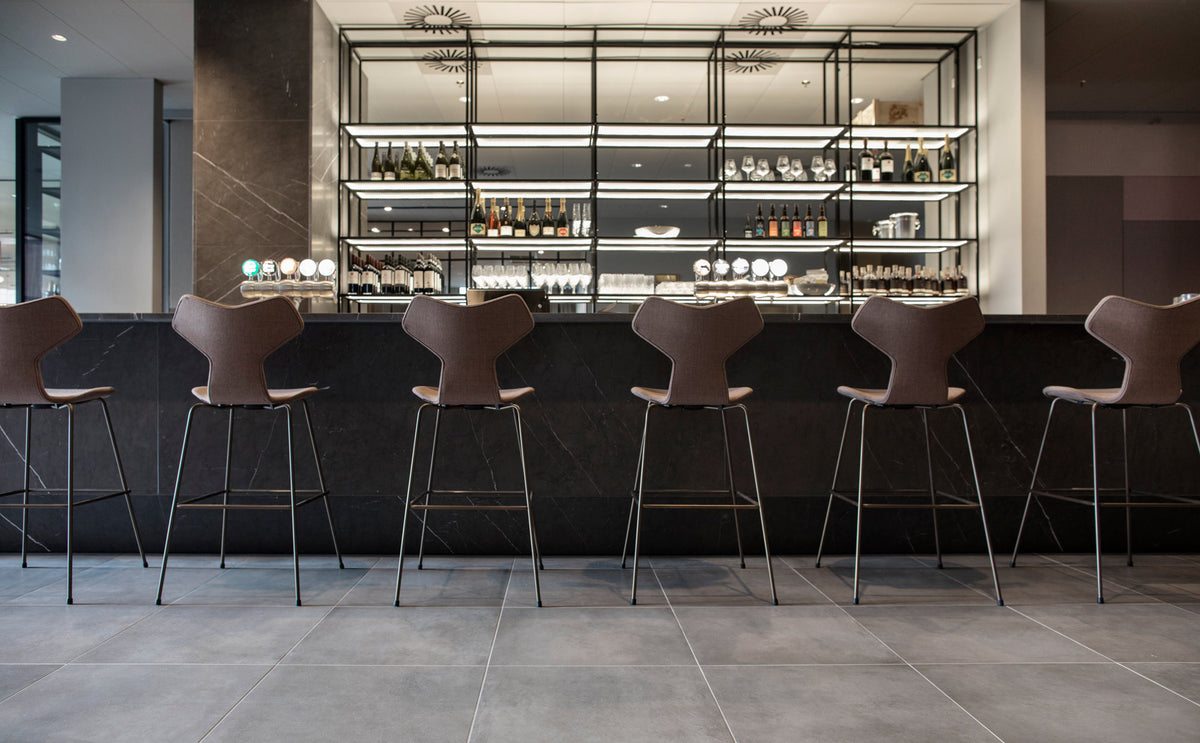 Grand Prix Full Upholstery Stool by Fritz Hansen, showing grand prix full upholstery stools in live shot.