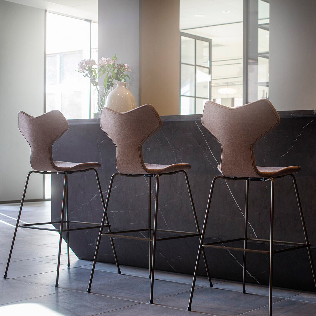 Grand Prix Full Upholstery Stool by Fritz Hansen, showing grand prix full upholstery stools in live shot.