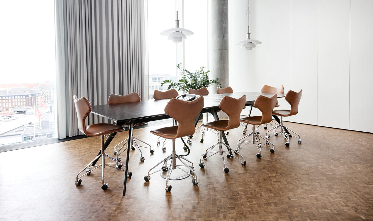 Grand Prix Full Upholstery Swivel Chair by Fritz Hansen, showing grand prix full upholstery swivel chairs in live shot.
