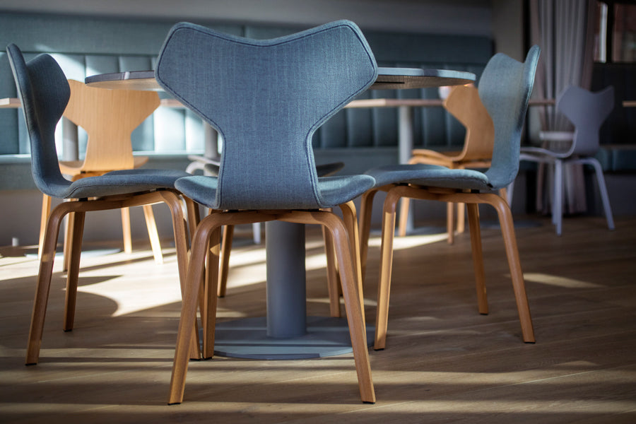 Grand Prix Full Upholstery Wooden Legs Chair by Fritz Hansen, showing grand prix full upholstery wooden legs chairs in live shot.