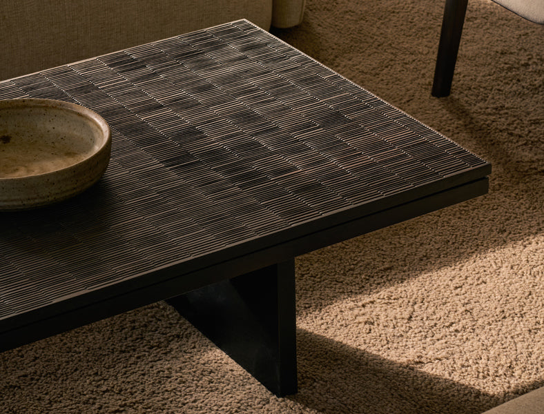 Grooves Coffee Table by Ethnicraft, showing closeup view of grooves coffee table in live shot.